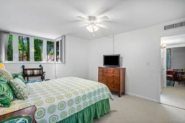 a bedroom with a bed and a television