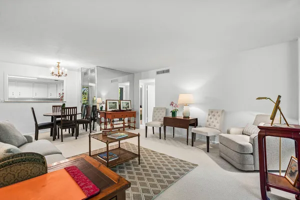 a living room with furniture dining area and a table