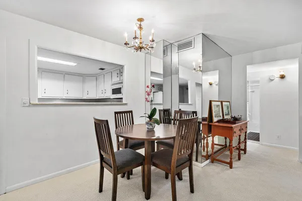 a view of a dining room with furniture and chandelier