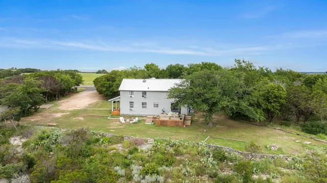 an aerial view of a house with a yard