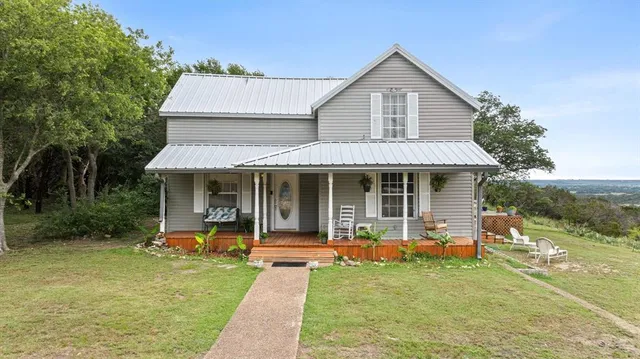 a view of a house with sitting area and garden
