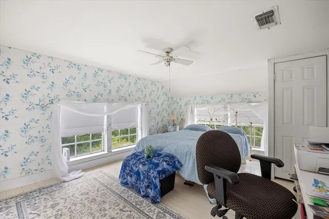 a workspace with wooden floor and a window