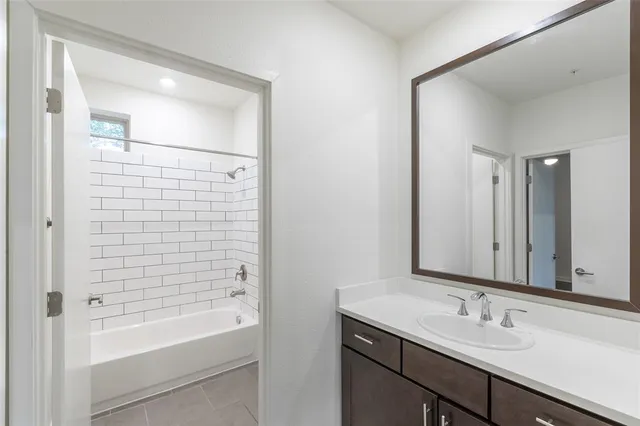 a view of a hallway with toilet and tub