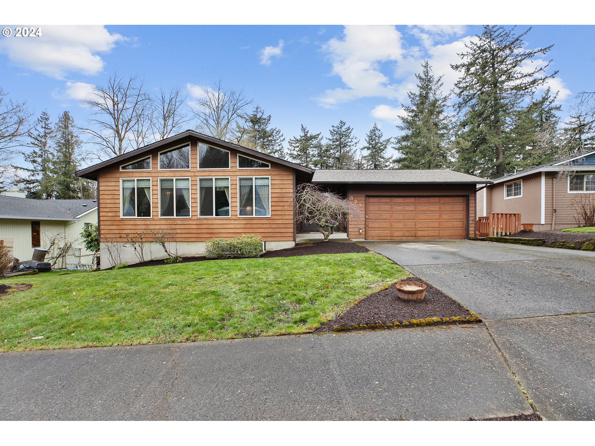 321 Northeast Scott Drive Gresham, OR 97030 - Photo 1 of 48 a front view of a house with a yard and garage