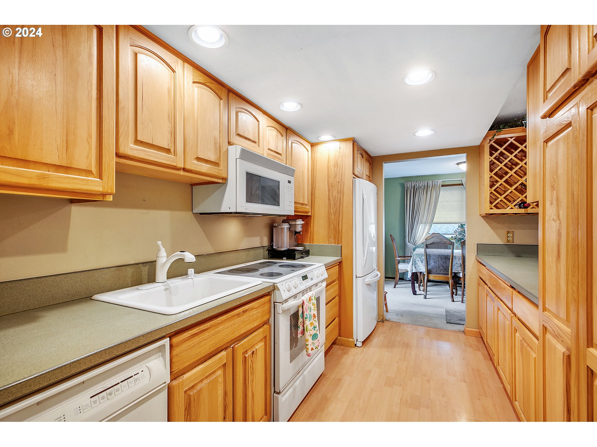 321 Northeast Scott Drive Gresham, OR 97030 - Photo 16 of 48 a kitchen that has a lot of cabinets in it and wooden floors