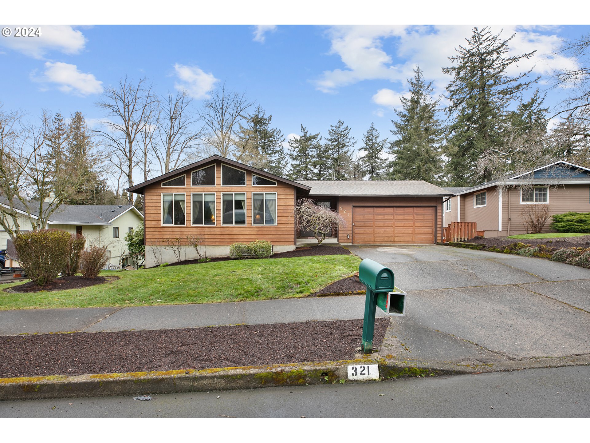 321 Northeast Scott Drive Gresham, OR 97030 - Photo 2 of 48 a front view of a house with a yard and garage