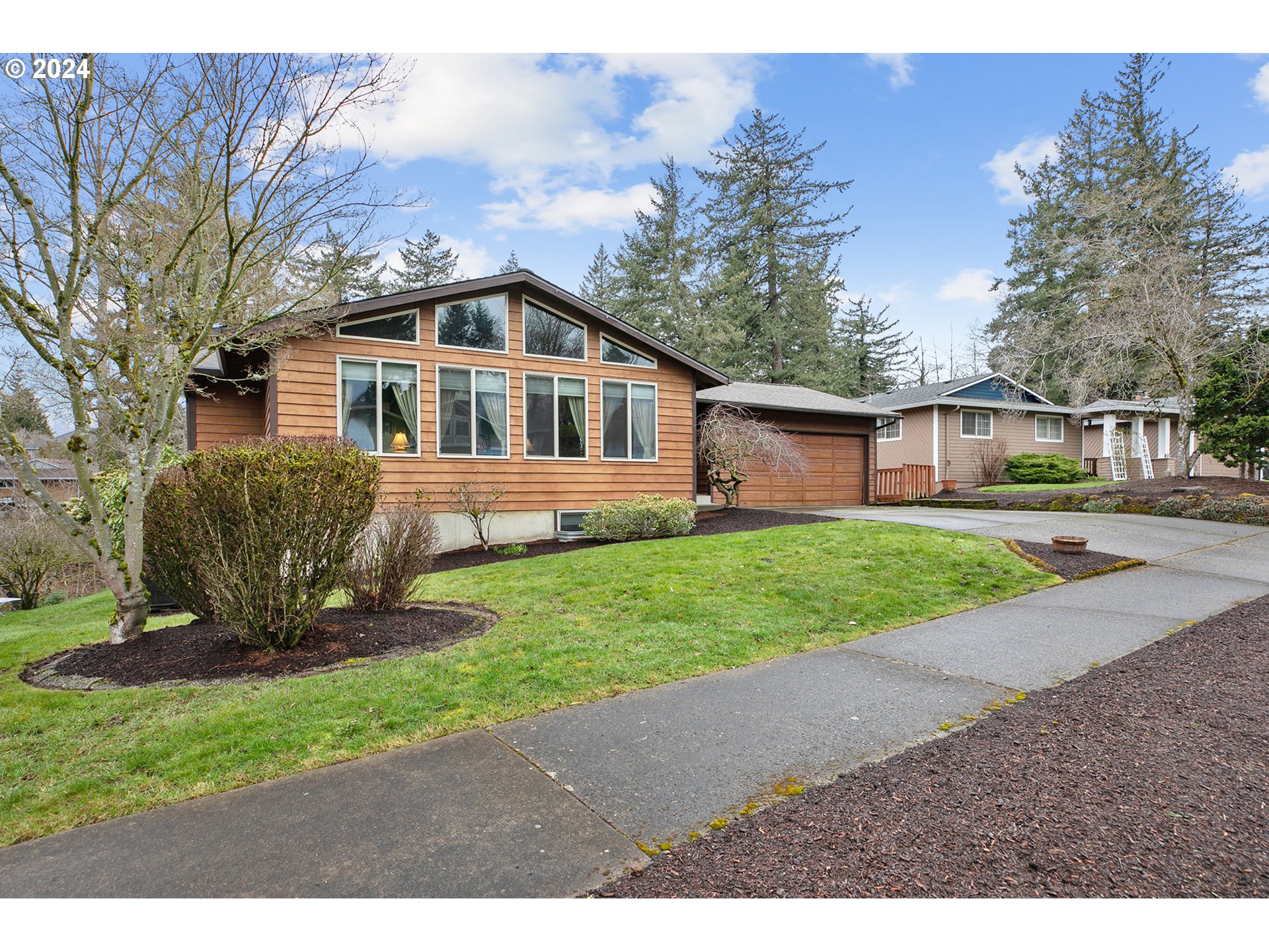 321 Northeast Scott Drive Gresham, OR 97030 - Photo 3 of 48 a front view of a house with a yard and trees