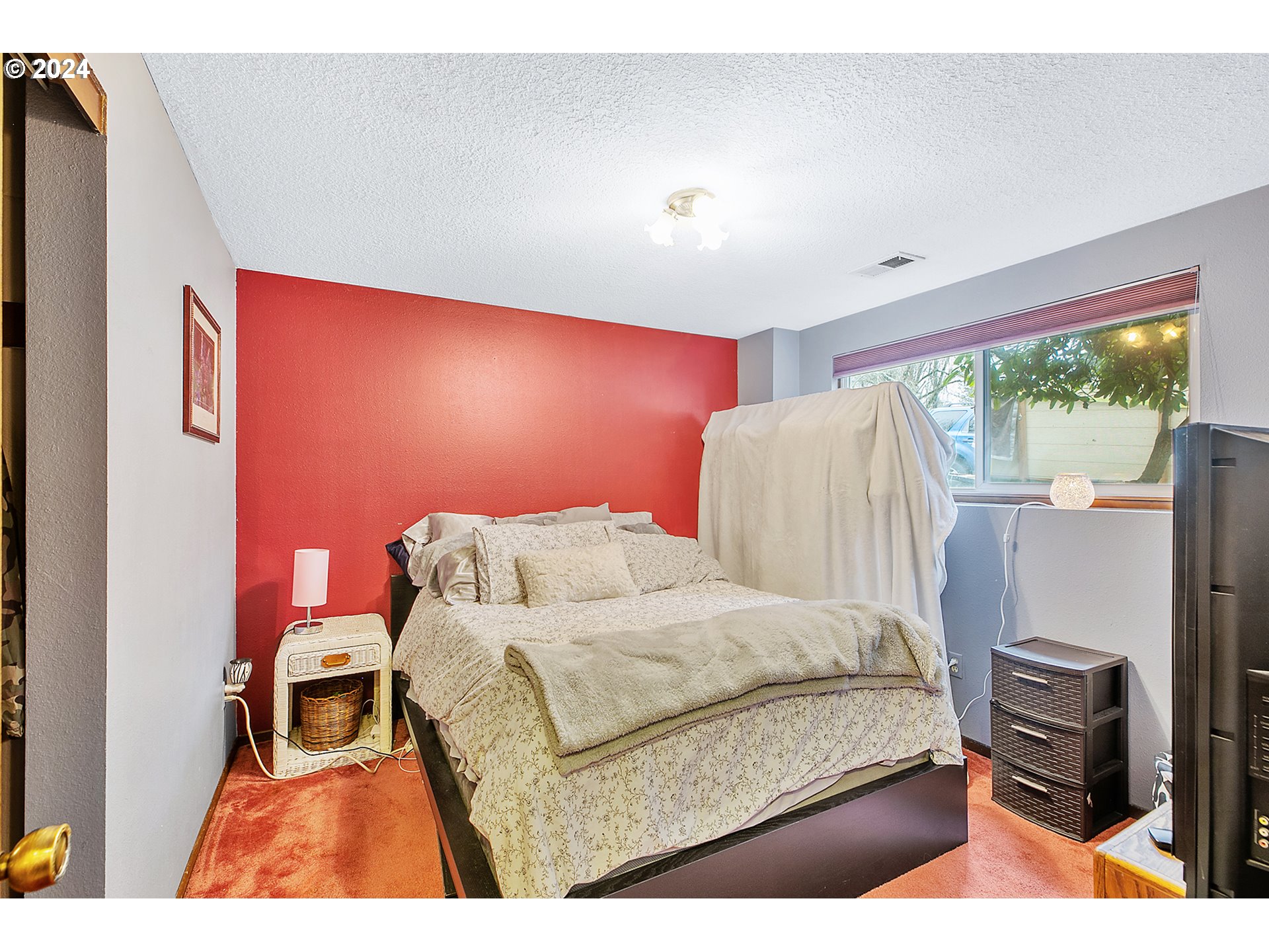 321 Northeast Scott Drive Gresham, OR 97030 - Photo 35 of 48 a bedroom with a bed and a flat tv screen on the dresser