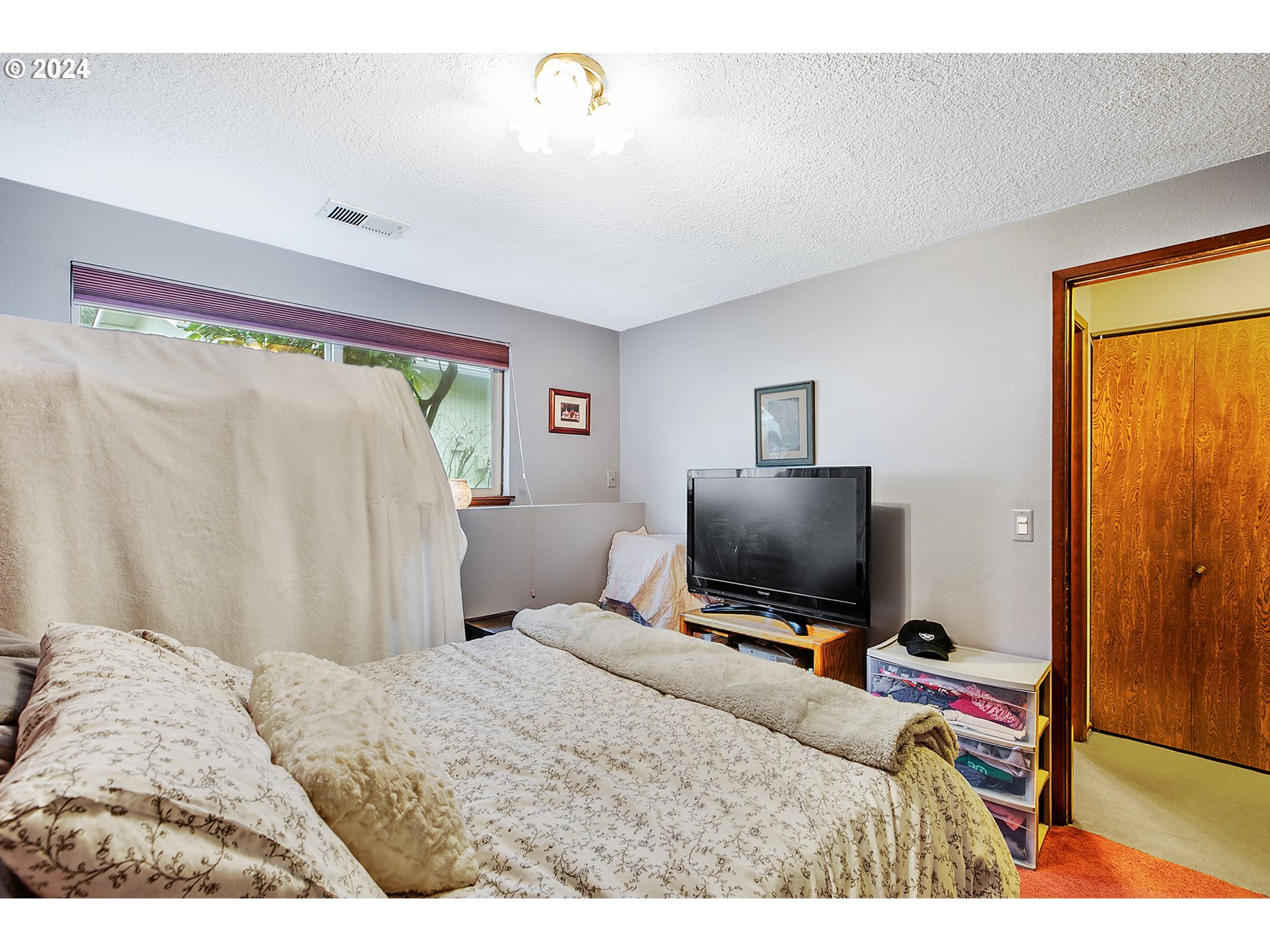 321 Northeast Scott Drive Gresham, OR 97030 - Photo 36 of 48 a bedroom with a bed and flat screen tv