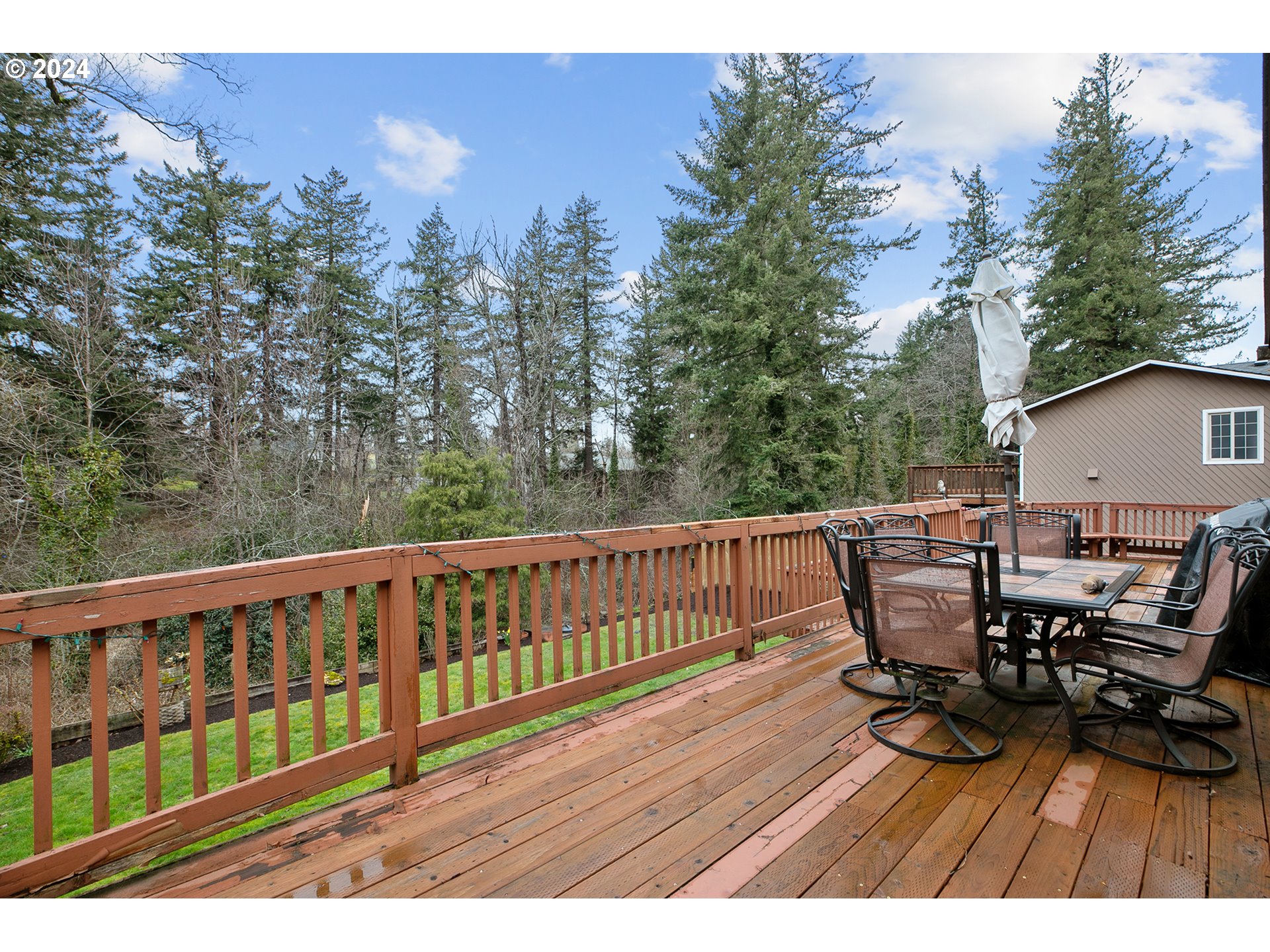 321 Northeast Scott Drive Gresham, OR 97030 - Photo 41 of 48 a view of a deck with a table and chairs with wooden floor