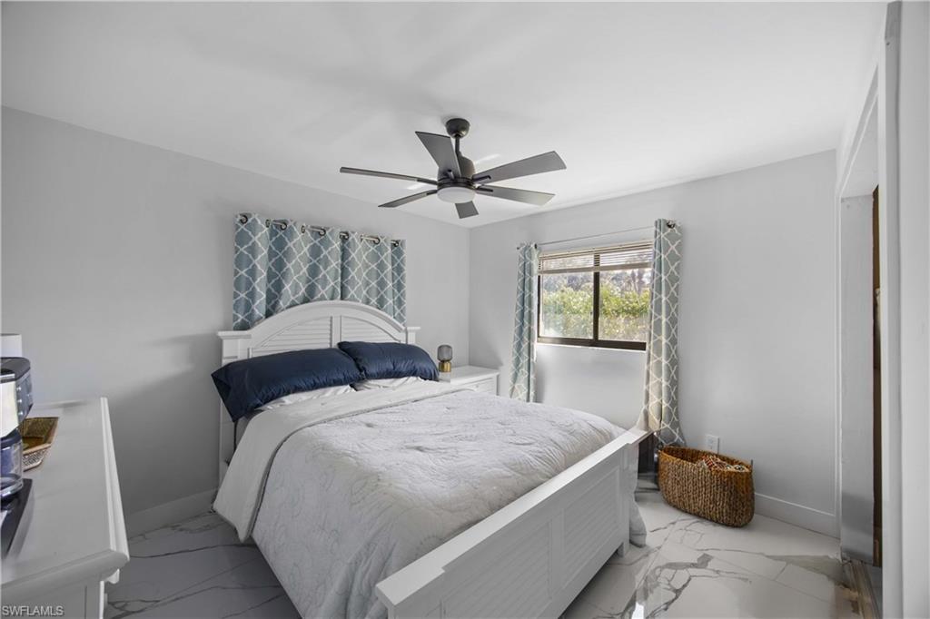 1890 Oakes Boulevard, Unit A Naples, FL 34119 - Photo 16 of 50 a bedroom with a bed and window