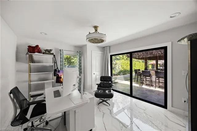 a living room with furniture and floor to ceiling windows