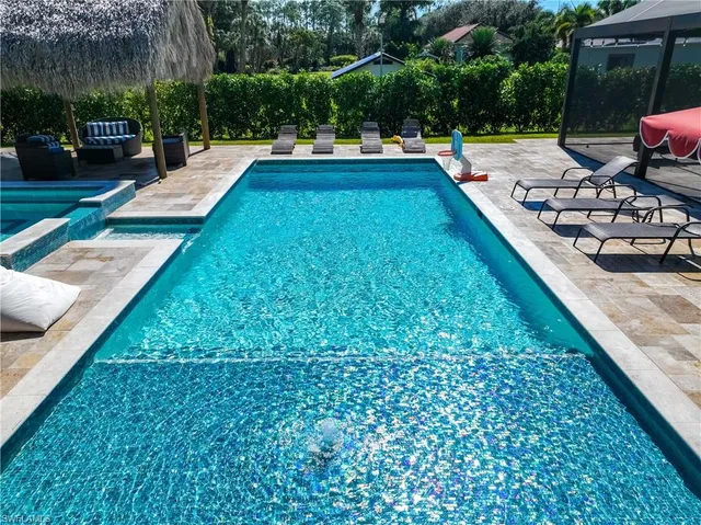 swimming pool view with a seating space