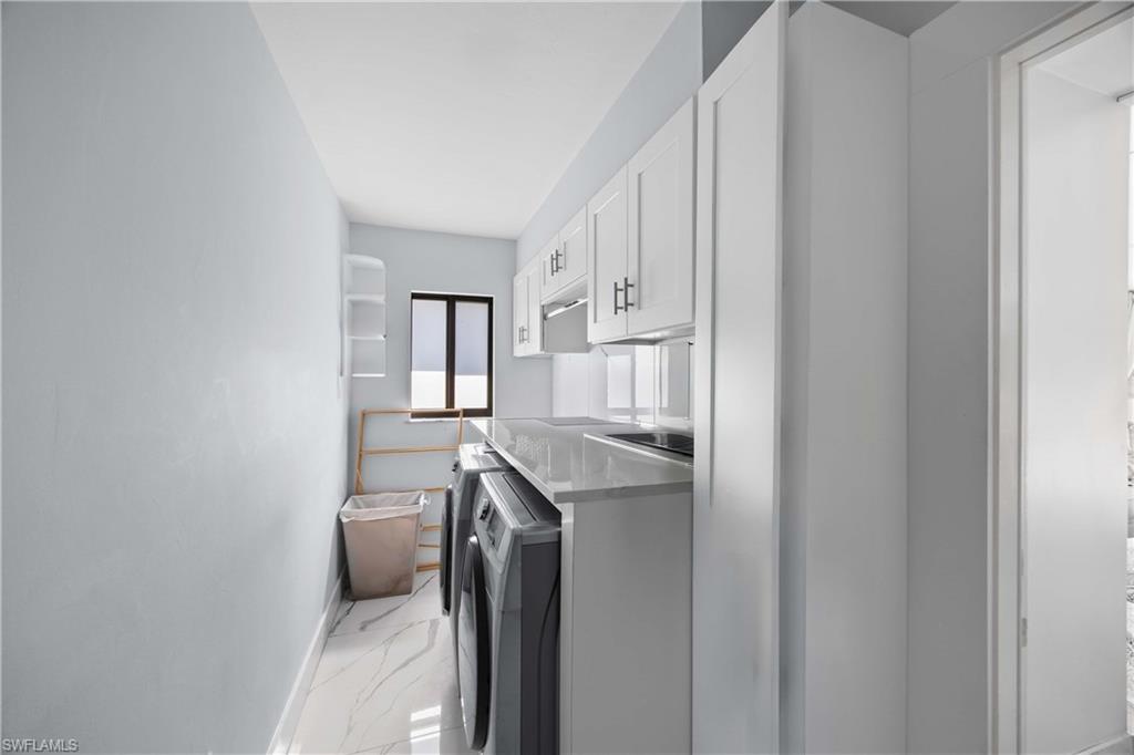 1890 Oakes Boulevard, Unit A Naples, FL 34119 - Photo 21 of 50 a utility room with cabinets washer and dryer