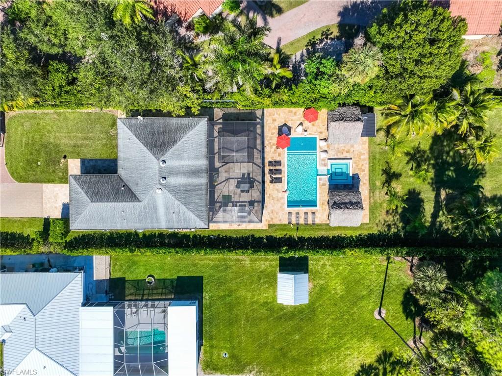 1890 Oakes Boulevard, Unit A Naples, FL 34119 - Photo 46 of 50 an aerial view of residential houses with outdoor space and trees
