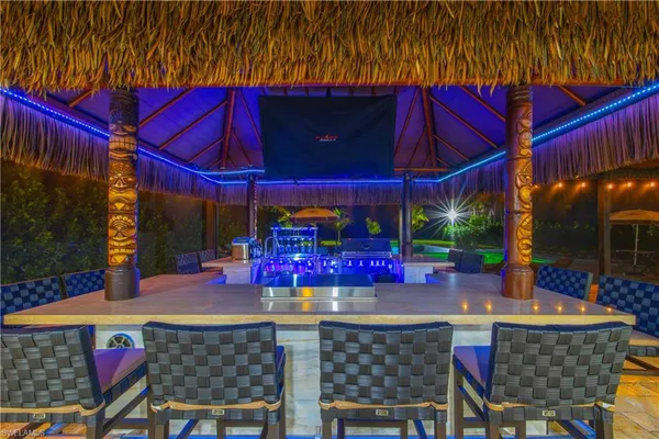 a view of a patio with a table and chairs under an umbrella