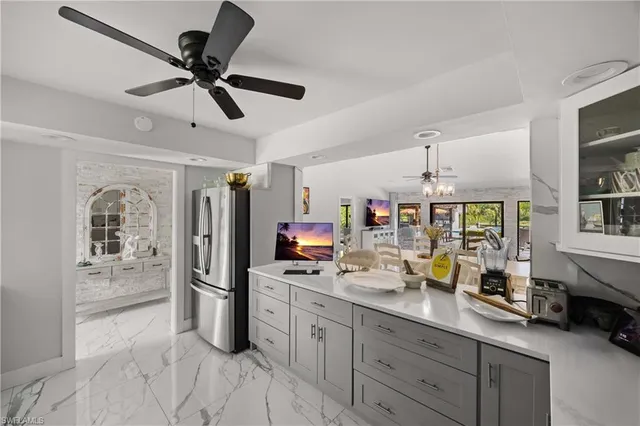 a kitchen with granite countertop white cabinets and black appliances