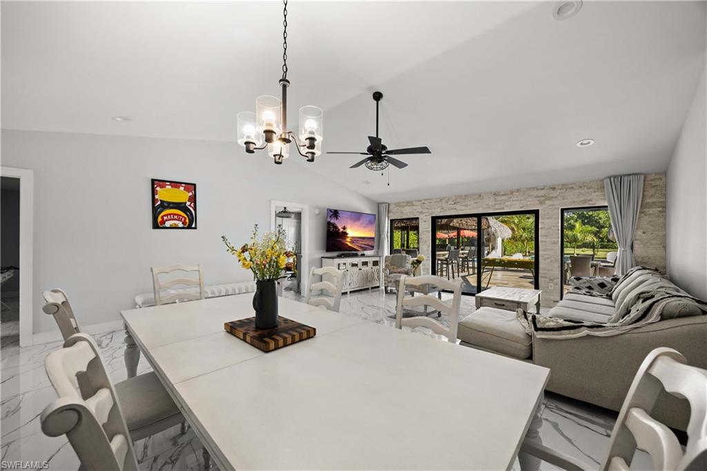 1890 Oakes Boulevard, Unit A Naples, FL 34119 - Photo 8 of 50 a living room with fireplace furniture and a chandelier