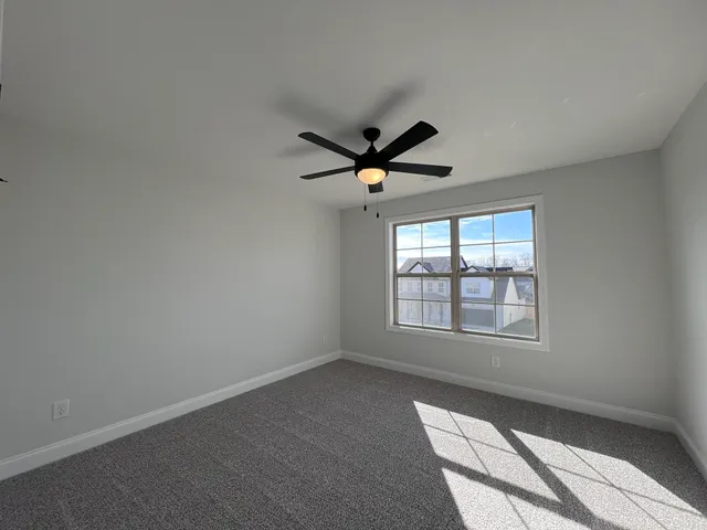a bathroom with a granite countertop double vanity sink and a mirror