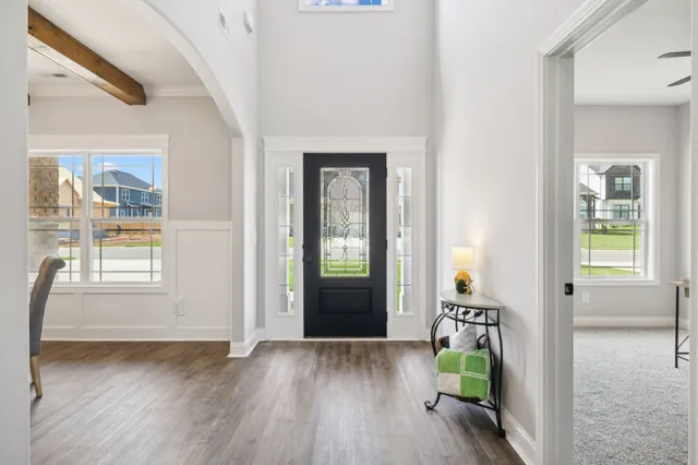 a kitchen with kitchen island granite countertop a sink cabinets and wooden floor