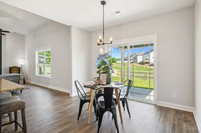 a bathroom with a granite countertop double vanity sink and a mirror