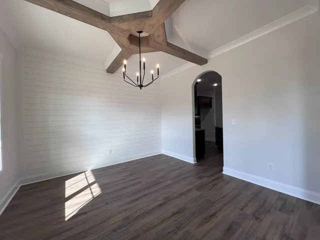 a kitchen with granite countertop kitchen island stainless steel appliances a sink stove and refrigerator