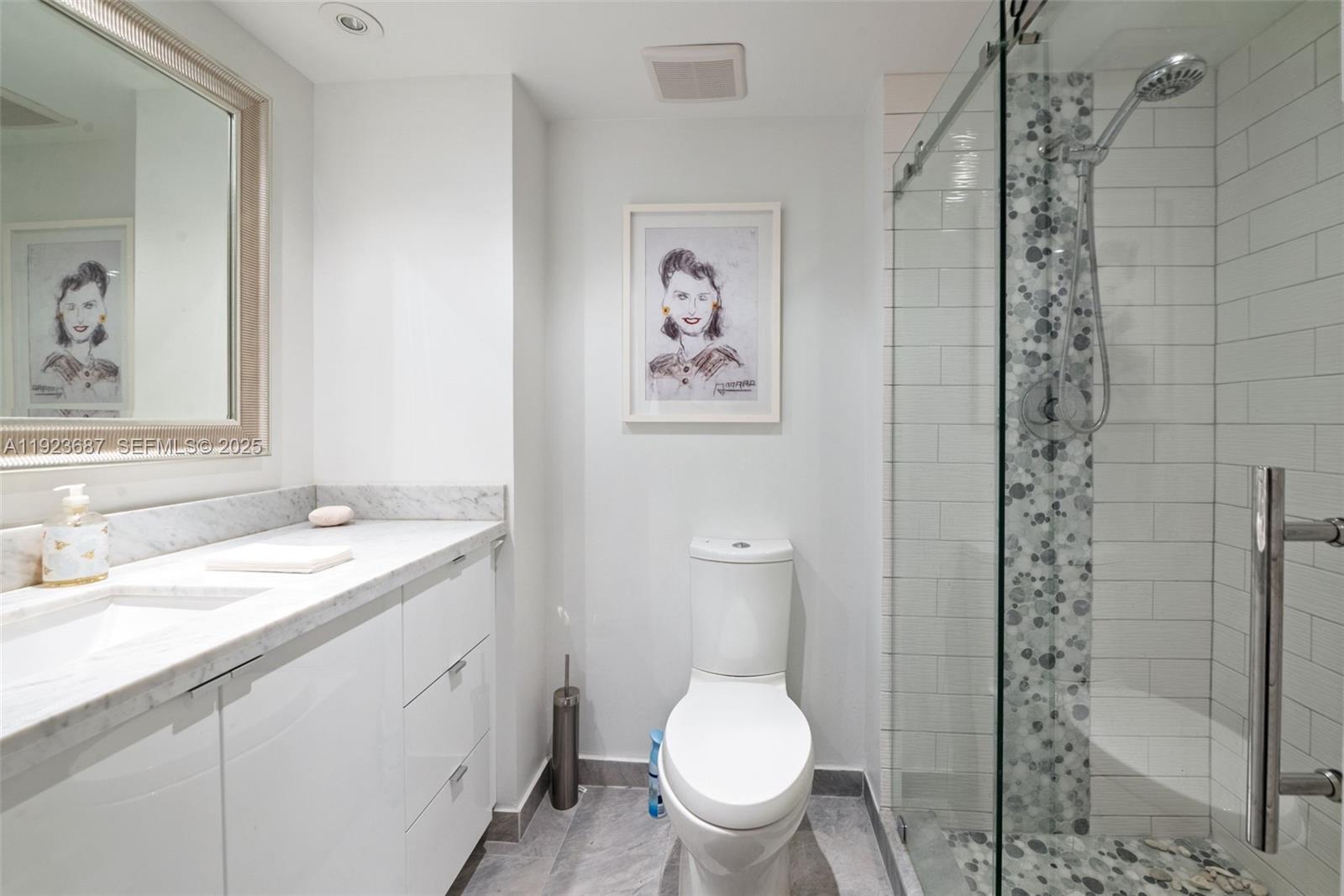 20185 East Country Club Drive, Unit 904 Aventura, FL 33180 - Photo 11 of 29 a bathroom with a granite countertop sink toilet and shower