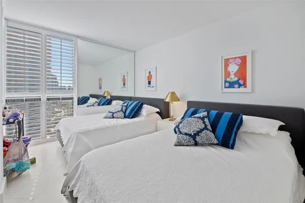 a bed room with a bed and a painting on the wall