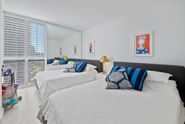 a bed room with a bed and a painting on the wall