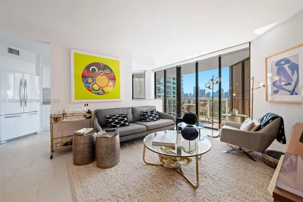 a living room with furniture and a floor to ceiling window