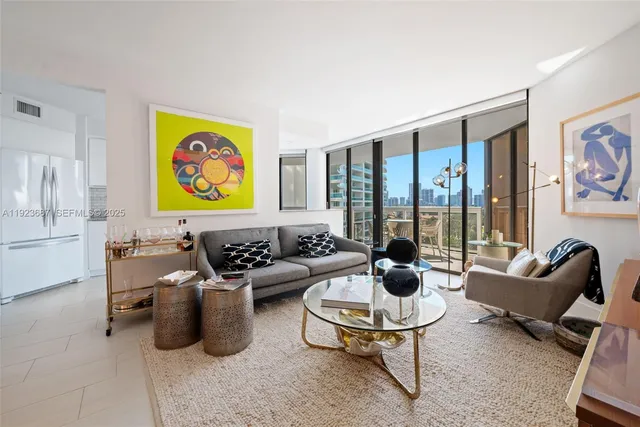 a living room with furniture and a floor to ceiling window