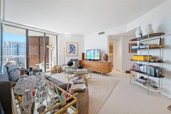 a living room with furniture and a large window