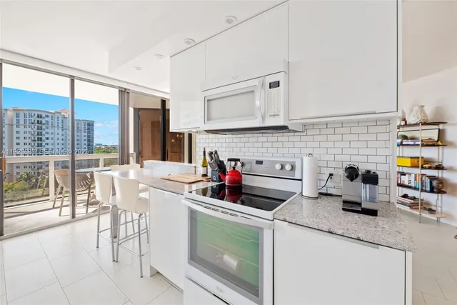 a kitchen with a stove a sink and a microwave