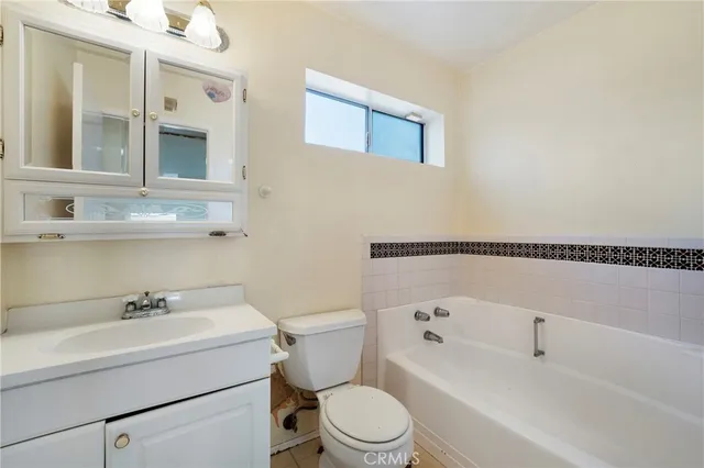a white toilet sitting next to a bathroom sink