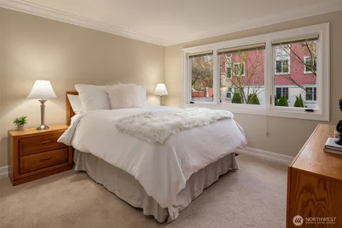 a spacious bedroom with a bed and a large window