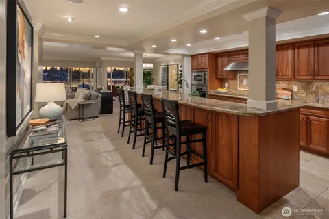 a kitchen with lots of wooden furniture a dining table and chairs