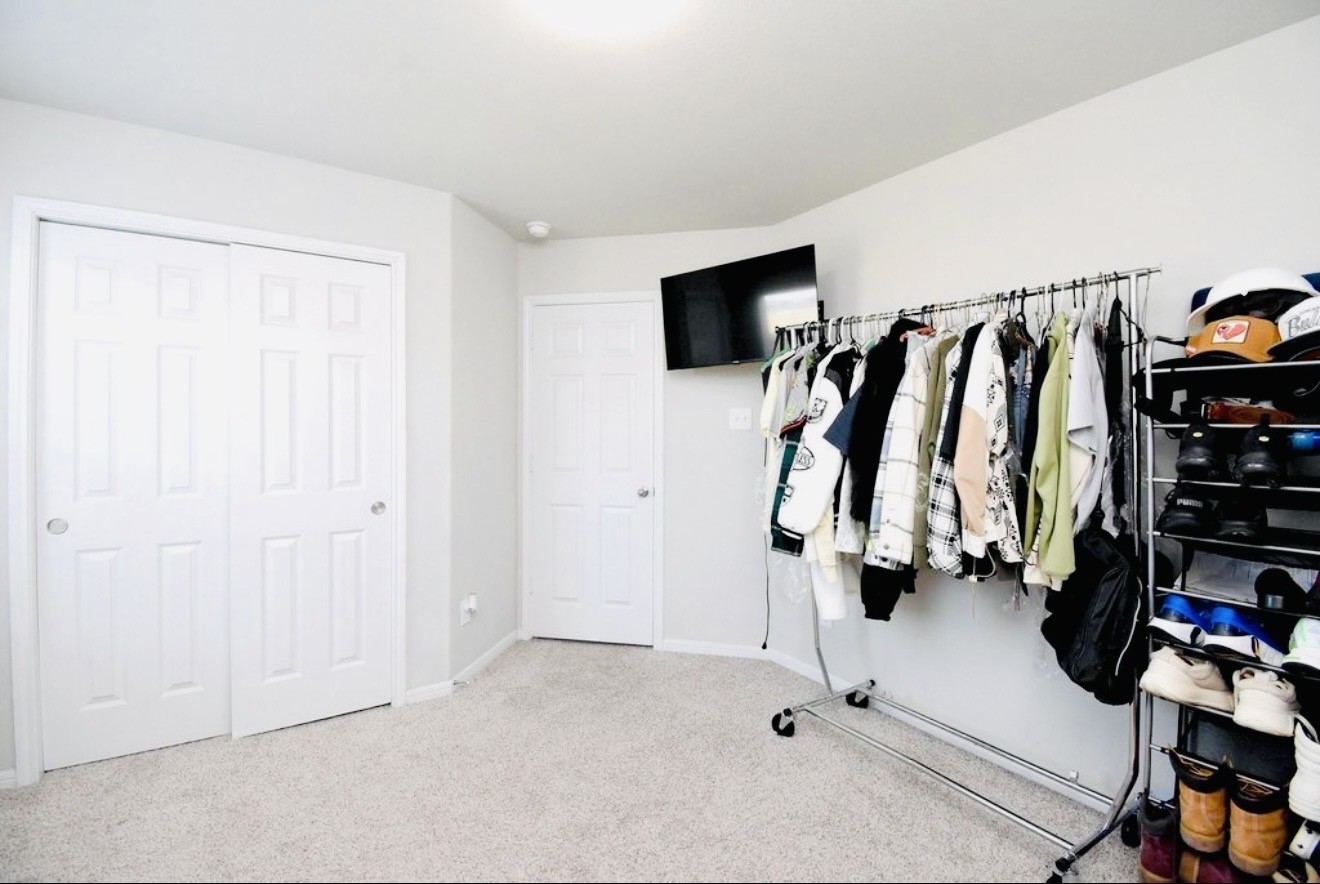 4303 Greeley Lane Rosenberg, TX 77471 - Photo 11 of 30 a view of walk in closet with clothes