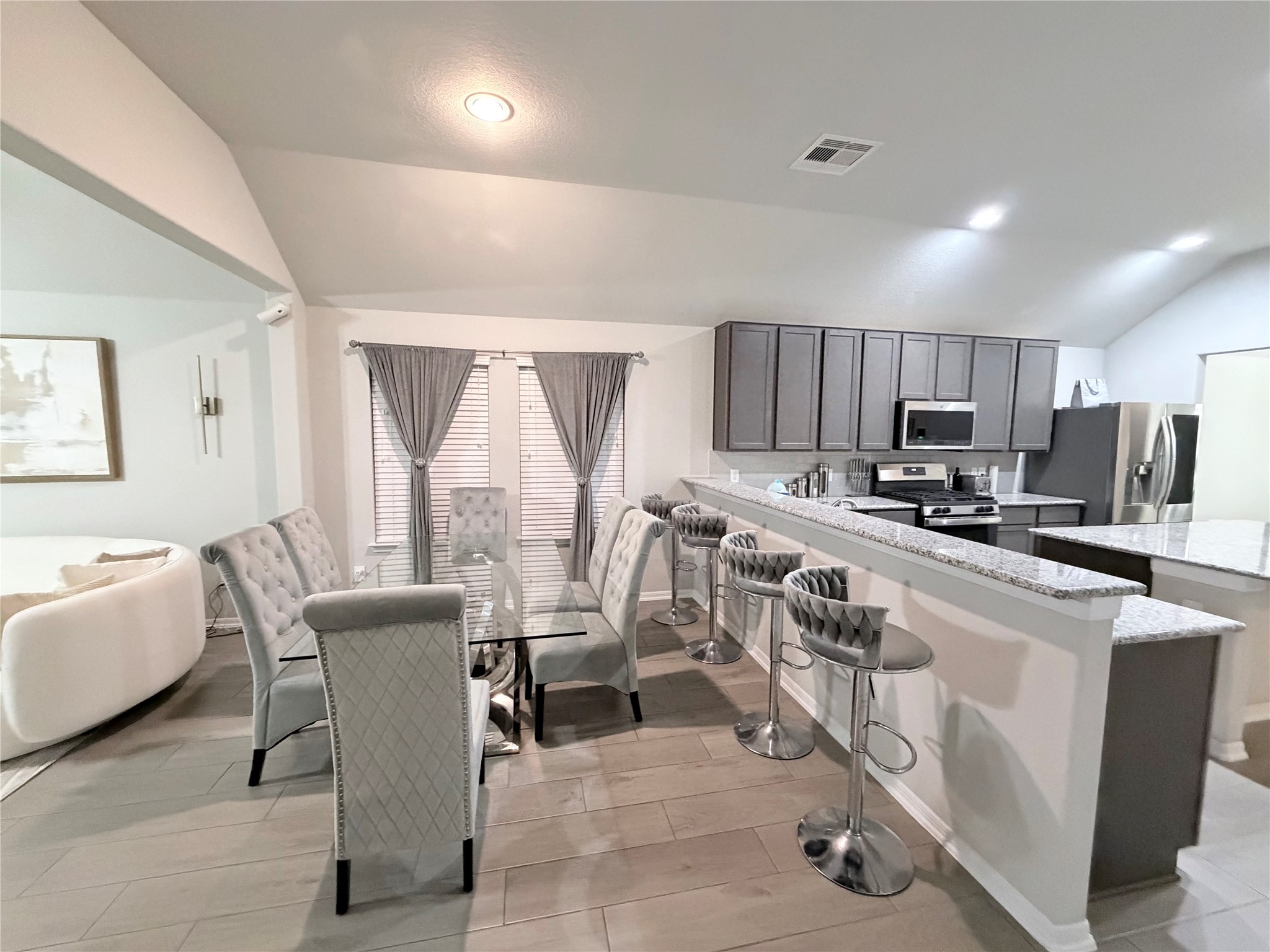 4303 Greeley Lane Rosenberg, TX 77471 - Photo 23 of 30 a kitchen with granite countertop lots of white cabinets appliances and a dining table