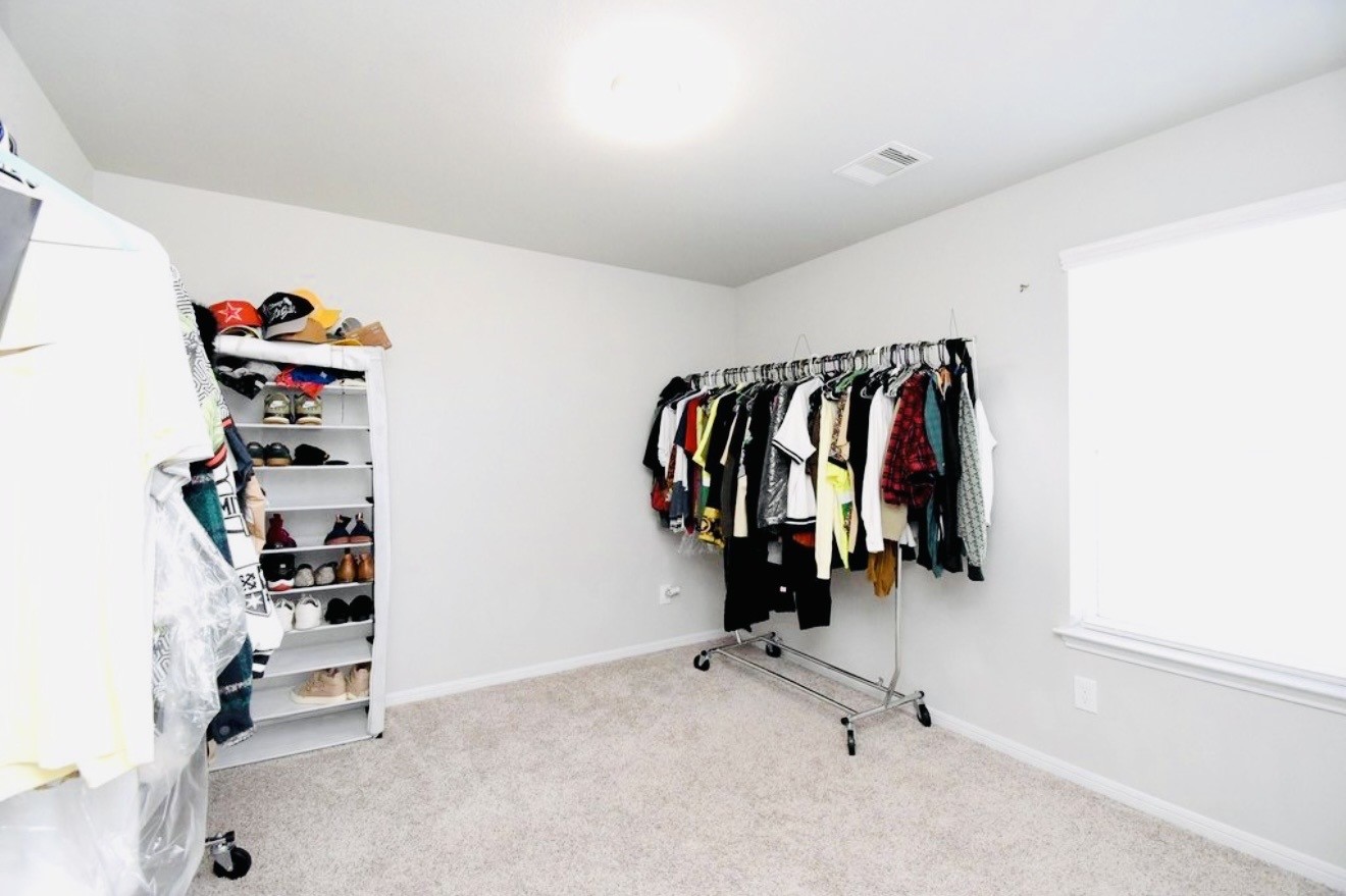 4303 Greeley Lane Rosenberg, TX 77471 - Photo 10 of 30 a view of walk in closet with clothes and shoes