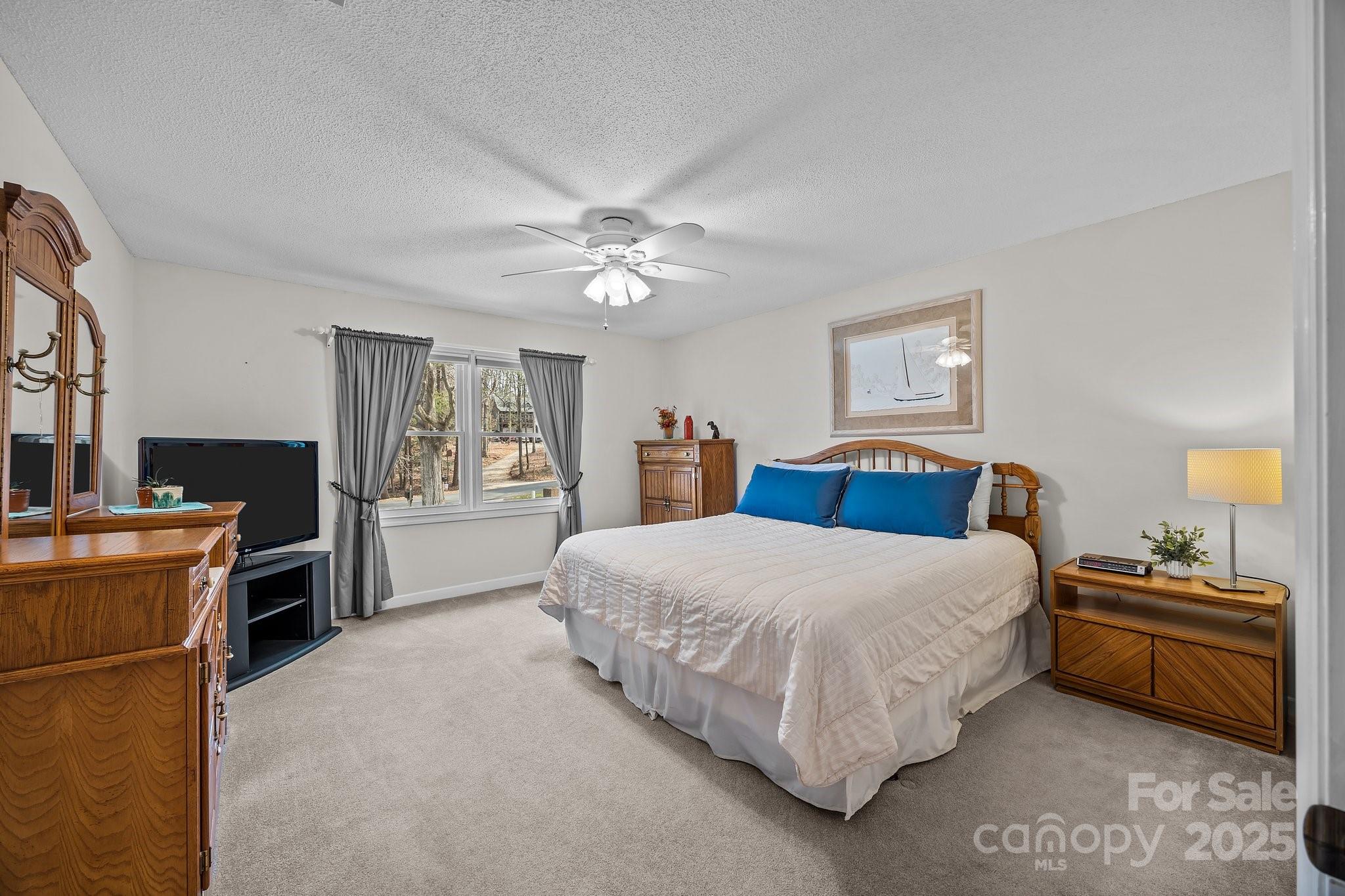 520 Mainsail Road Salisbury, NC 28146 - Photo 14 of 47 a bedroom with a bed and a chandelier