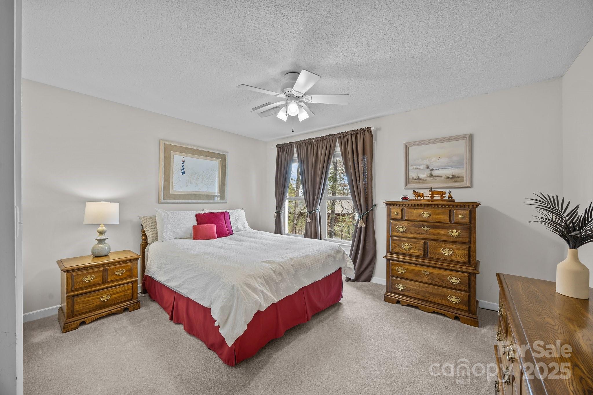 520 Mainsail Road Salisbury, NC 28146 - Photo 26 of 47 a bedroom with a bed and a chandelier