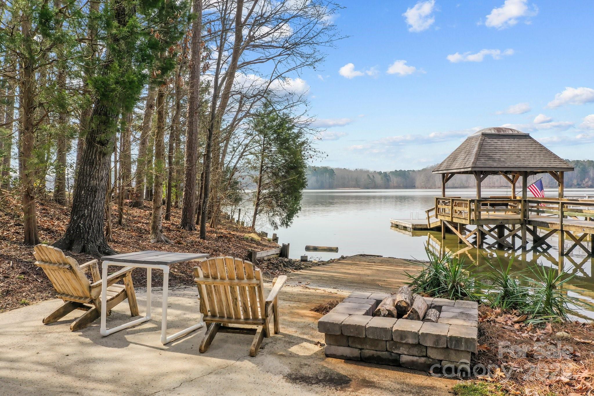 520 Mainsail Road Salisbury, NC 28146 - Photo 29 of 47 a view of a patio with table and chairs under an umbrella