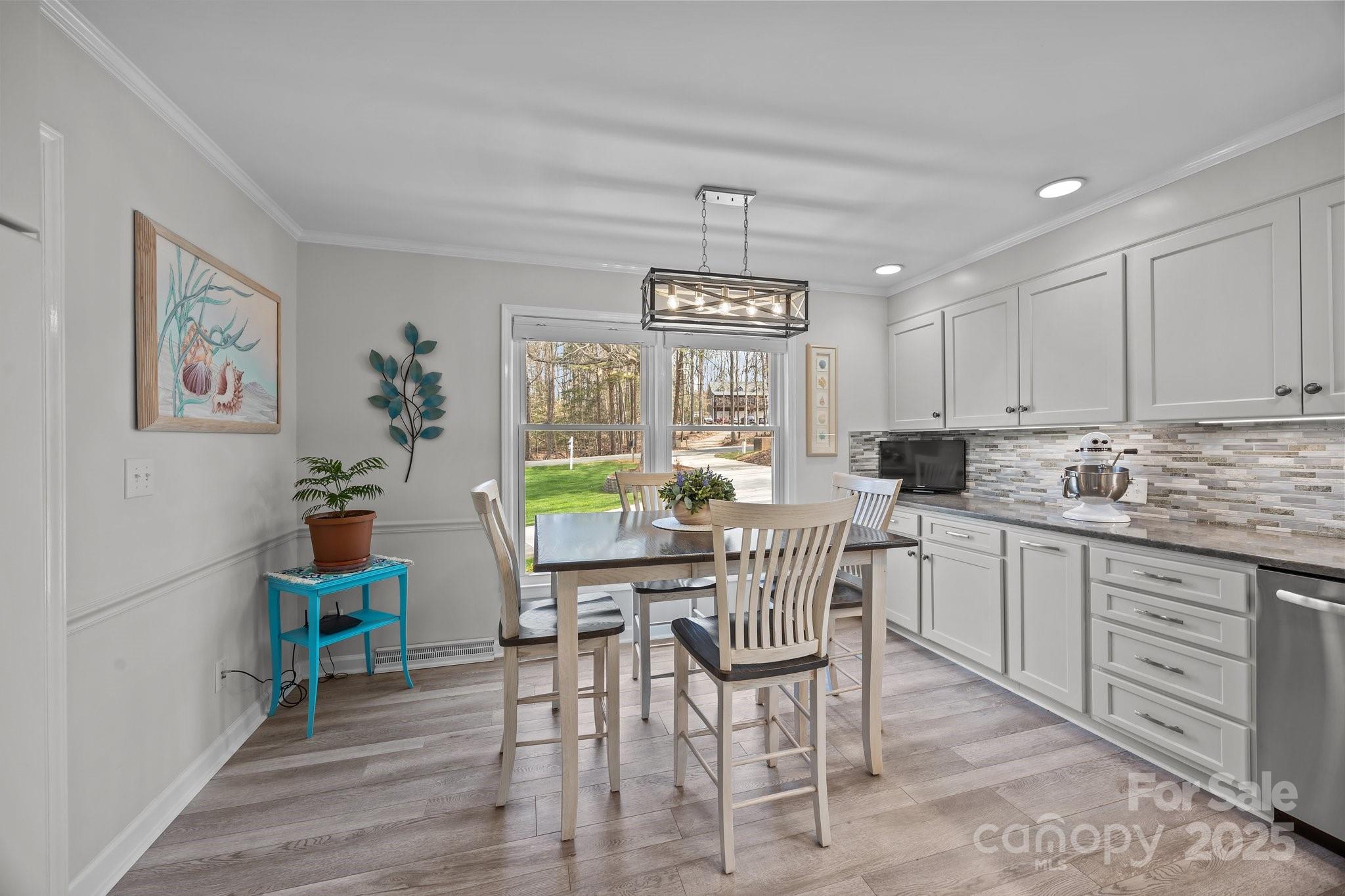 520 Mainsail Road Salisbury, NC 28146 - Photo 10 of 47 a kitchen with a dining table chairs and large window