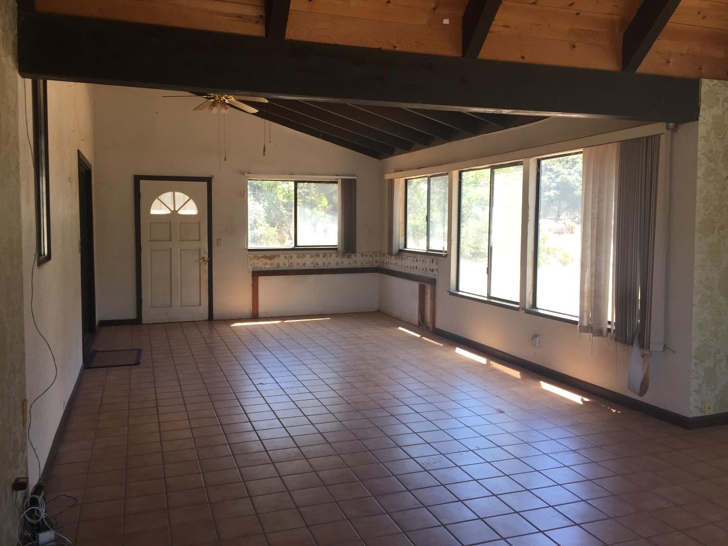 392 Vega Road Watsonville, CA 95076 - Photo 28 of 38 a view of an empty room with wooden floor and a window
