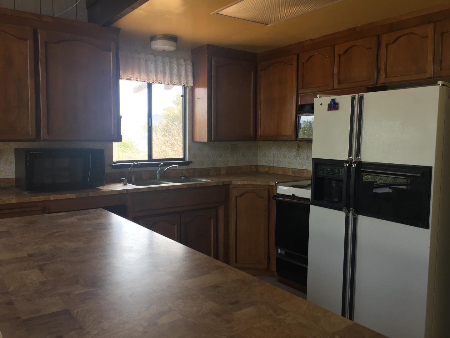 392 Vega Road Watsonville, CA 95076 - Photo 31 of 38 a kitchen with granite countertop a refrigerator and a sink