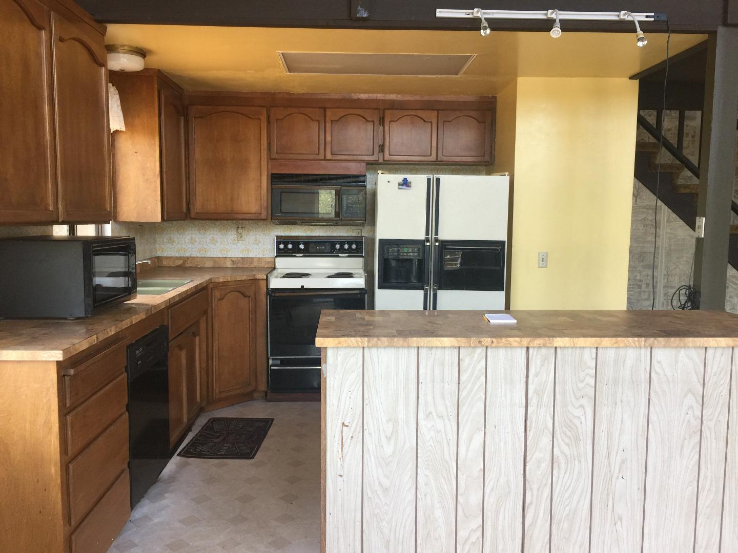392 Vega Road Watsonville, CA 95076 - Photo 32 of 38 a kitchen with stainless steel appliances a sink a stove a refrigerator cabinets and a window
