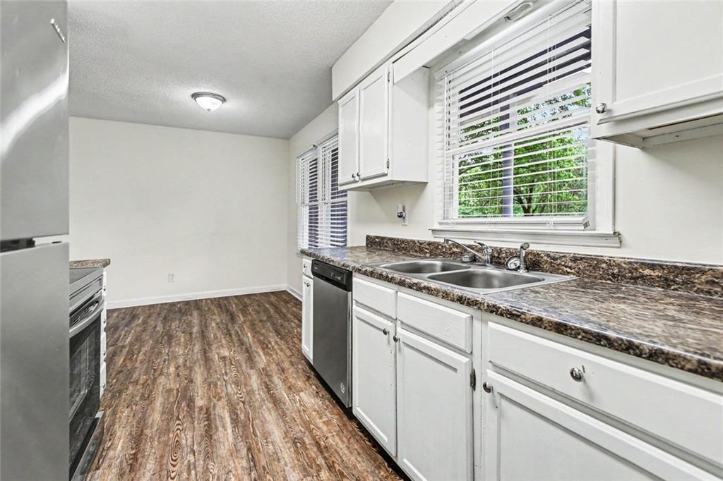 19 Thomas Way Newnan, GA 30263 - Photo 11 of 15 a kitchen with a sink stove and cabinets