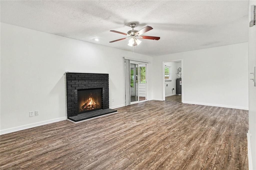 19 Thomas Way Newnan, GA 30263 - Photo 2 of 15 a view of an empty room with a fireplace and a window