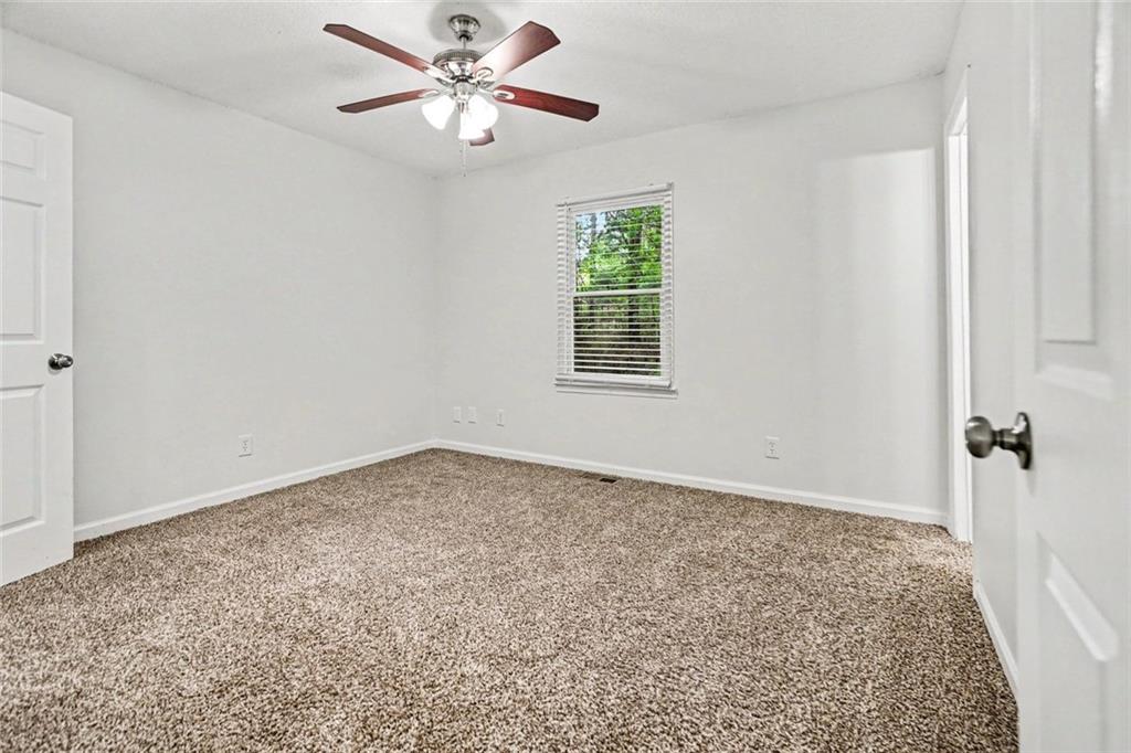 19 Thomas Way Newnan, GA 30263 - Photo 4 of 15 an empty room with windows and fan