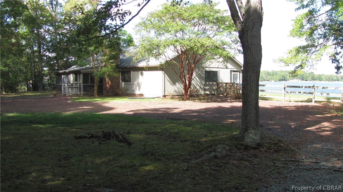 1266 Queenstown Road Lancaster, VA 22503 - Photo 2 of 46 a view of a yard in front of a house with large trees